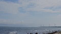 Wind turbines operating along the Sea of Japan coast, Tottori Prefecture, Japan.