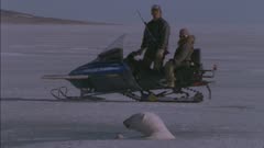 Inuit Father &amp; Son Skidoo Up To A Polar Bear In Seal Hole &amp; POV of Polar Bear in Seal Hole