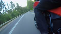 Man riding a sports motorcycle on a curved road