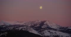 Moon in the sky over the snow-capped peaks of the Southern Cascade Range near Mt. Shasta