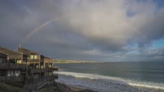 Rainbow over ocean and beach houses in Monterey