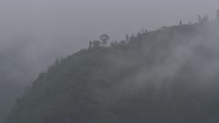 Nepal - August 1, 2015: Monsoon, forest, hill, mist rising