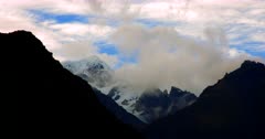 Time Lapse of the Fiordland silhouetted hill tops covered in snow with clouds swirling