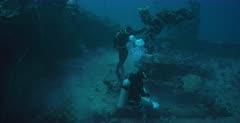 Divers retrieving oil off the Shinkoku shipwreck.