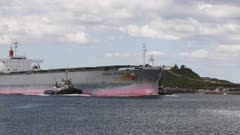 Coal bulk carrier accompanied into Newcastle, Australia by three tugboats.