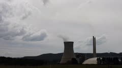 Steaming cooling towers of a coal fired power station. Filmed on a warm summers evening.