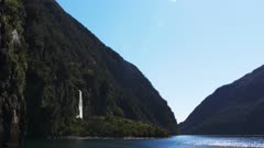 a shot of bridal veil falls in milford sound on a sunny spring day