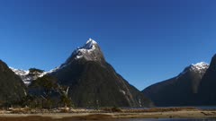 a zoom in shot of mitre peak in milford sound, new zealand