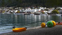 a shot of watercraft and the buildings on the waterfront of queenstown, new zealand
