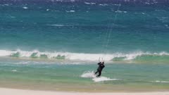 a kite boarder rides waves and gets air- recorded at 1080p 60fps