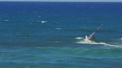 a wind surfer sails upwind at ho'okipa, maui