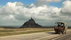a horse drawn wagon returns from mont st michel in normandy france