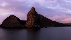 sunrise view of pinnacle rock at isla bartolome from a cruise ship in the galalagos islands, ecuador