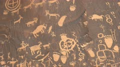 tilt down shot of ancient american indian drawings on newspaper rock at canyonlands national park in utah, usa