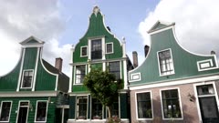 the front of several quaint old houses at zaanse schans village near amsterdam in the netherlands