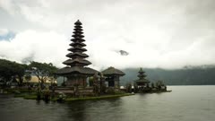 a misty afternoon time lapse of the meru at pura danu bratan temple in bali, indonesia