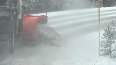 slow motion close up clip of a snow plow clearing part of the grand loop road in yellowstone national park of wyoming, usa
