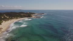 high aerial view of norah head lighthouse and pebbly beach on the central coast of nsw, australia