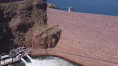 an aerial descending clip of the water outlet of lake argyle dam hydroelectric power station near kununurra in western australia