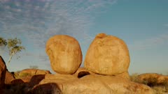 a sunset shot of a pair rocks at the devil's marbles in the northern territory