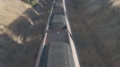 an overhead tilt up clip of a coal train in the upper hunter valley heading to the port of newcastle in nsw, australia