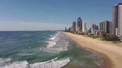 a morning aerial clip flying forwards and then backwards facing south on main beach at surfers paradise on the gold coast of qld, australia