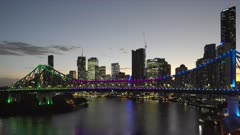 a summer evening shot of the city of brisbane, story bridge and river from wilson reserve in queensland, australia