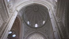 a tilt up clip of the interior of the domed roof of the mosque-cathedral of cordoba, spain