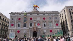 a front view of palau de la generalitat de catalunya decorated for sant jordi day in barcelona, spain