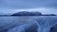 Pov shot at motor boat wave driving in norwegian fjord, wide gimbal shot