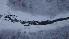 Aerial view of river and waterfall with pancake ice, sideways move