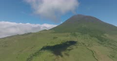 Aerial view of Pico volcano cloudscape / Azores, backwards move