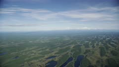 Aerial of the wide glacial-carved Matanuska-Susitna Valley, with Denali in the distance