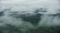 Aerial shot of clouds drifting over a boreal forest and lakes in Interior Alaska