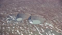 Sink holes in landscape in glacial morain near Fairweather range near Yakutat Alaska climate change melting glaciers