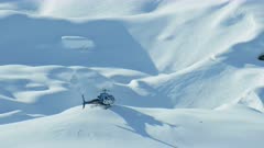 Alaska - September, 2017: Aerial view of helicopter about to take off in scenic snow covered Tordrillo mountains Wilderness area Kenai Peninsula North Pacific ocean USA