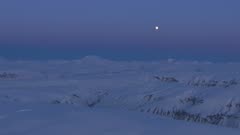 Aerial of Alaska Katmai scenic mountains range at night extreme wilderness in arctic winter under bright moon America