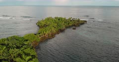 Aerial Drone shot of a tropical coastline in Central America showing clear water and reefs