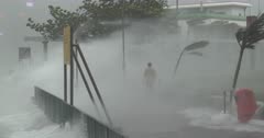 Hurricane Wind And Storm Surge Lash Man Walking Along Sea Wall