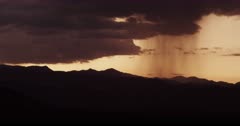 Summer thunderstorm and monsoon with distant rain shaft roaming across the desert
