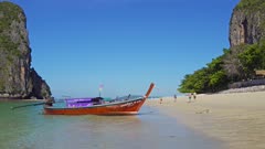 Long tail boat on tropical beach (Pranang beach) and rock, Krabi, Thailand, 4k