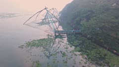 Traditional Chinese fishing nets at sunrise, Fort Kochi, India. Aerial drone view