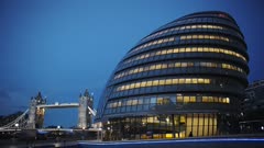 Modern Glass And Steel Structure Of The City Hall In London England Lighted In The Evening - wide shot