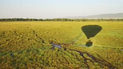 Low flying hot air balloon ride flight over empty African grassland savanna in Maasai Mara National Reserve, Kenya, Africa Safari adventure tours in Masai Mara North Conservancy