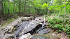 Natural gradual stream water flow stone ground zoom in