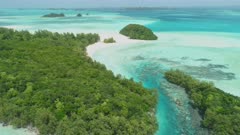 Aerial shot descending diagonally towards Ngemelis tropical island complex in Palau.