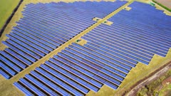 Aerial drone shot over large solar farm in UK 