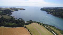 Aerial shot of Helford River estuary with farmland and boats. Cornwall, UK