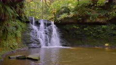 8K Static shot of waterfall and lush vegetation in Yorkshire woodland, UK