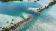 Aerial shot of tidal break in man-made causeway in Palmyra Atoll